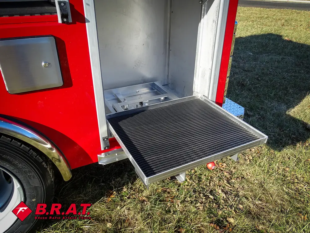 Lower side compartment with fold-down tray door and small items.