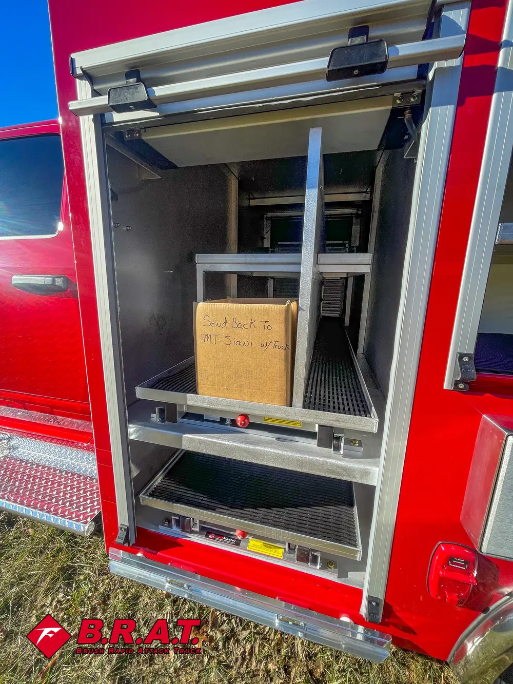 Vertical side bay open with shelf and cardboard box near top.
