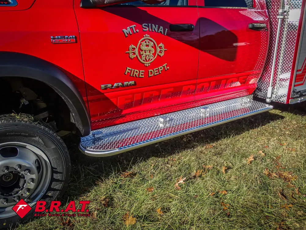 Driver-side cab door and side step close-up with department emblem.