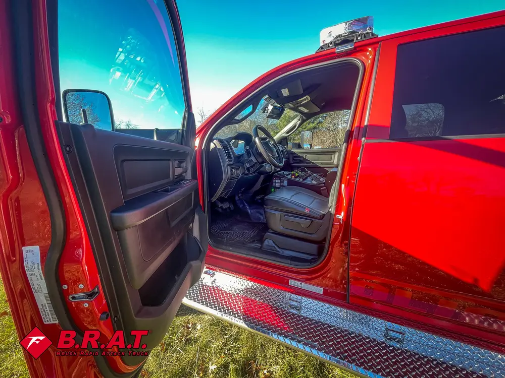 Open driver door view showing front seat and steering area.