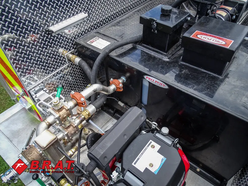 Exterior view of small fire truck showing cab, body compartments, and wheel/tire area.