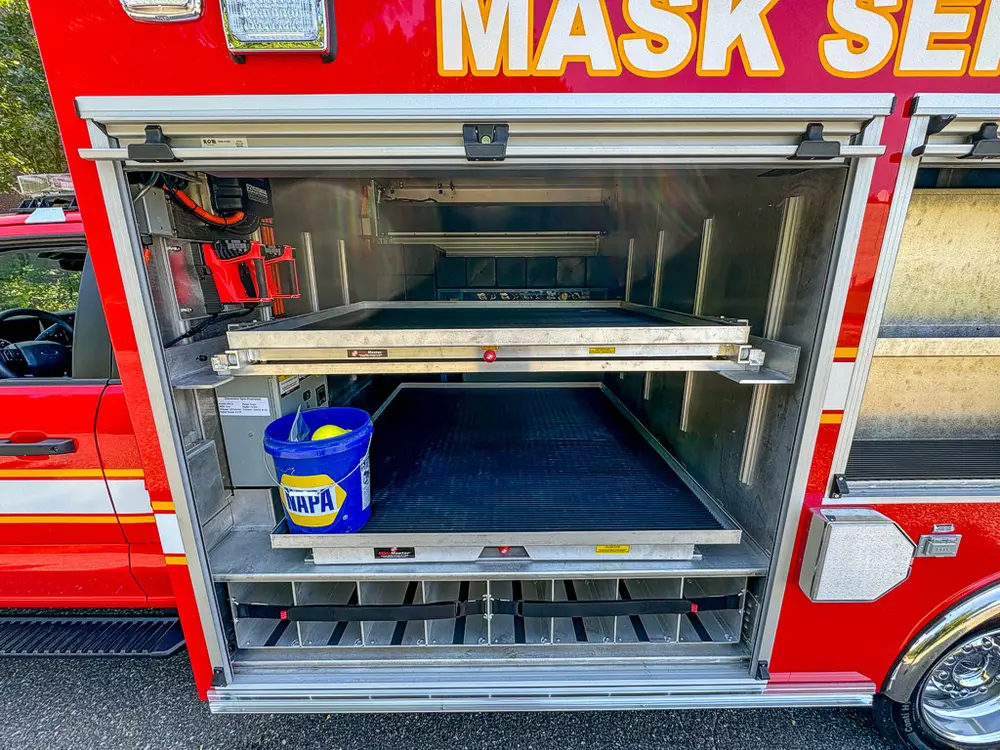 Open side compartment with slide-out shelf tray and empty upper bay.