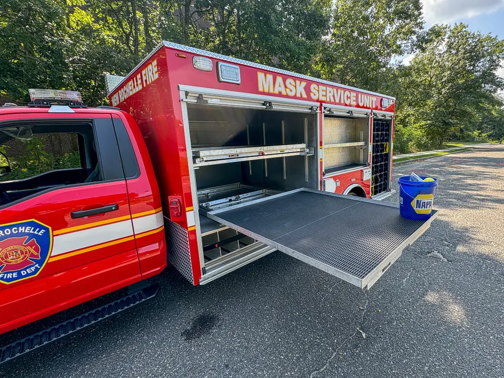 Two slide-out trays extended from side compartment opening.