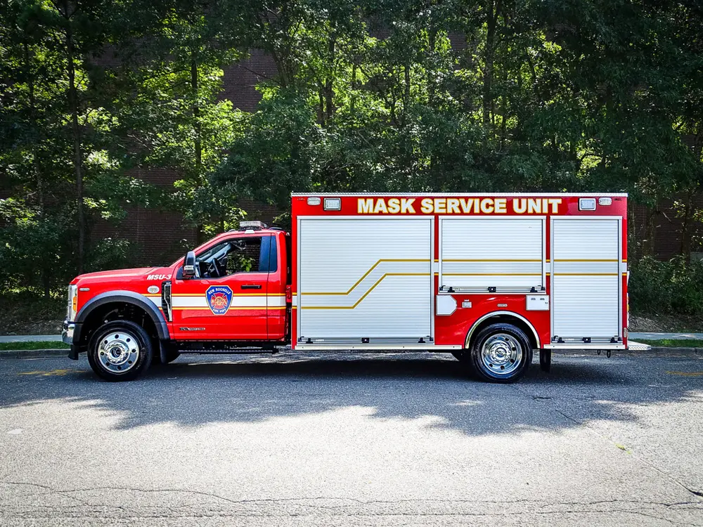 Full left-side profile showing cab and enclosed utility body.