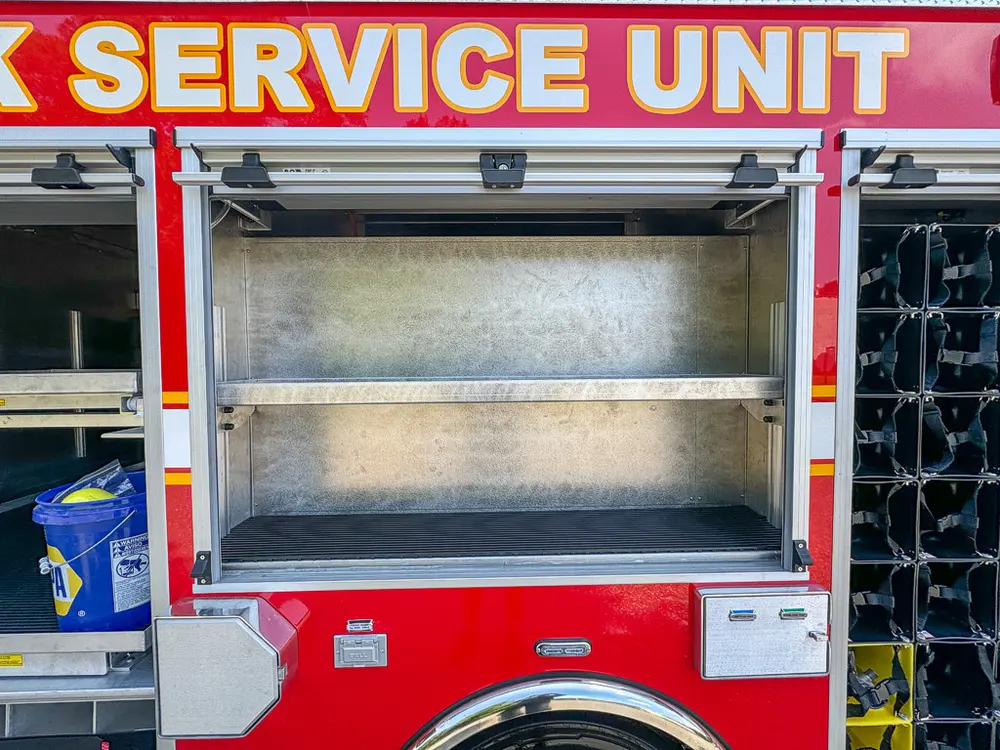 Open side shelving compartment with empty shelves and side controls.