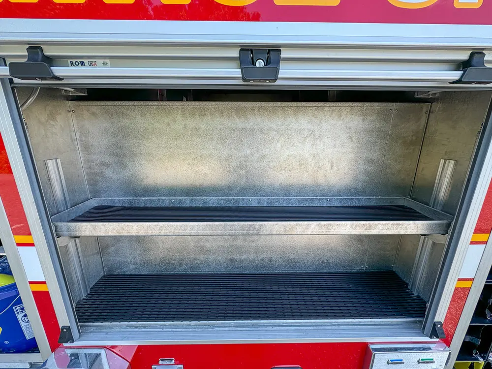 Open side compartment with single shelf and empty interior.