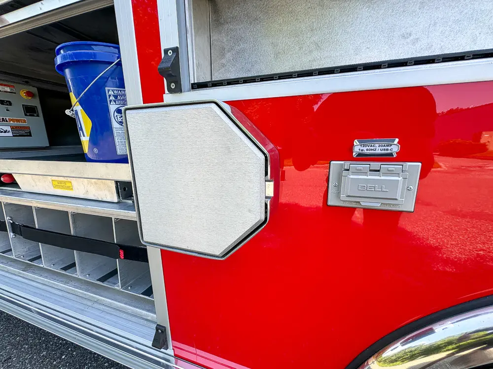 Small side hatch closed near mid-body compartment area.