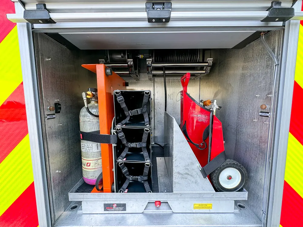 Rear center compartment with mounted extinguisher and fold-out tool rack.
