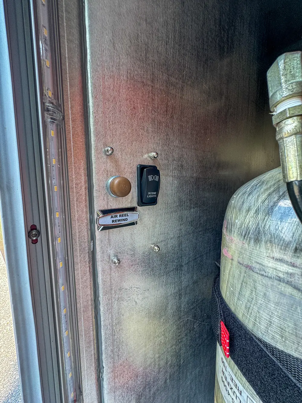 Compartment wall close-up with labeled switches and mounting points.