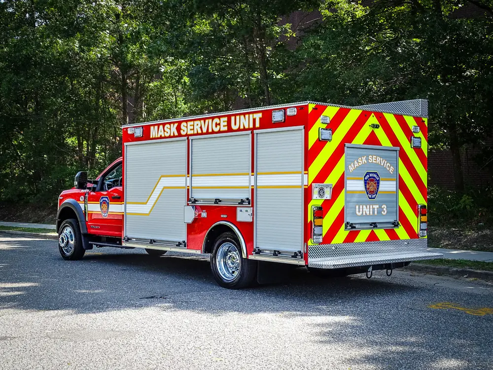 Rear-left three-quarter view with side compartments and rear chevrons.