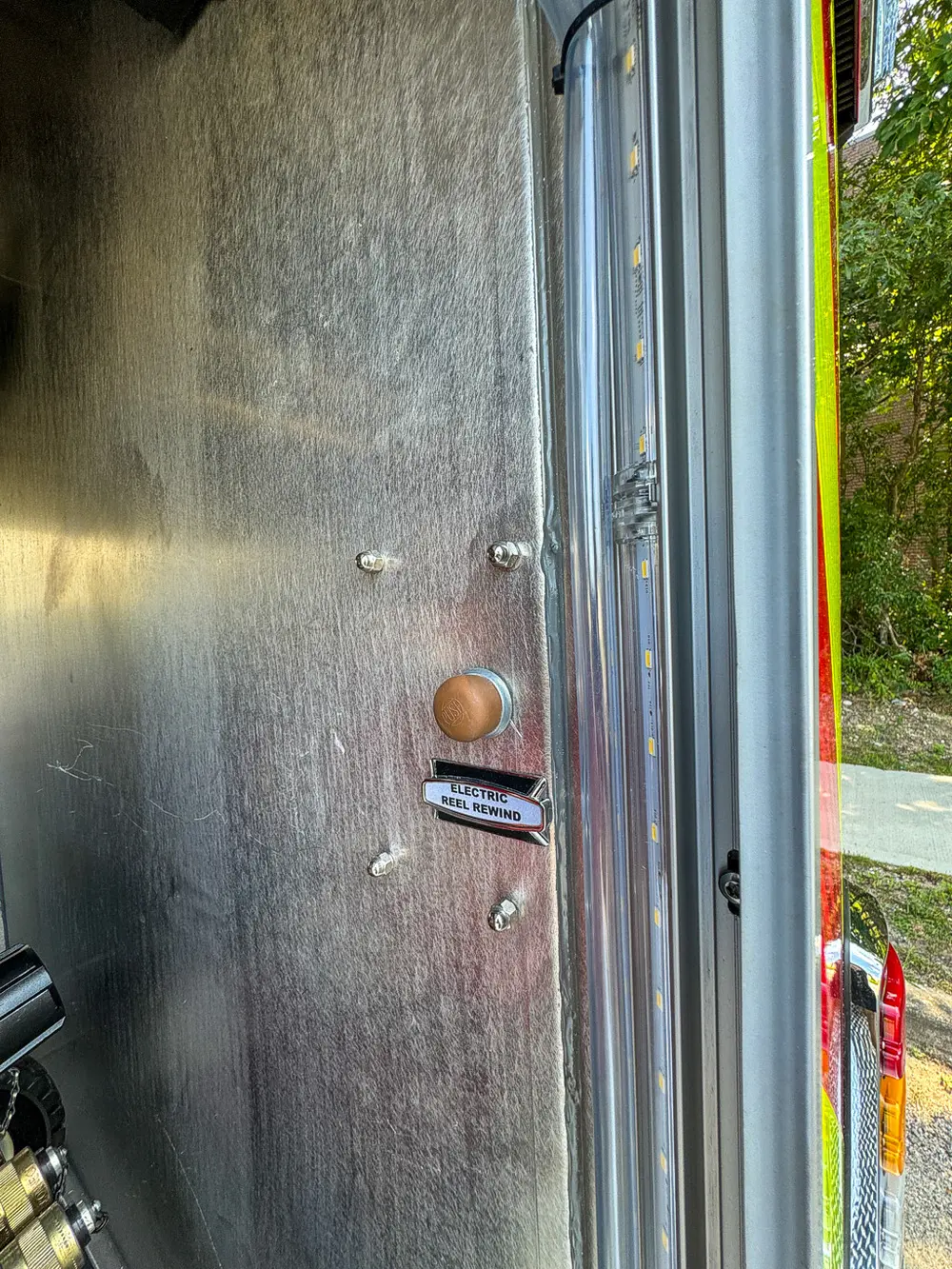 Interior compartment wall close-up with small labeled controls.