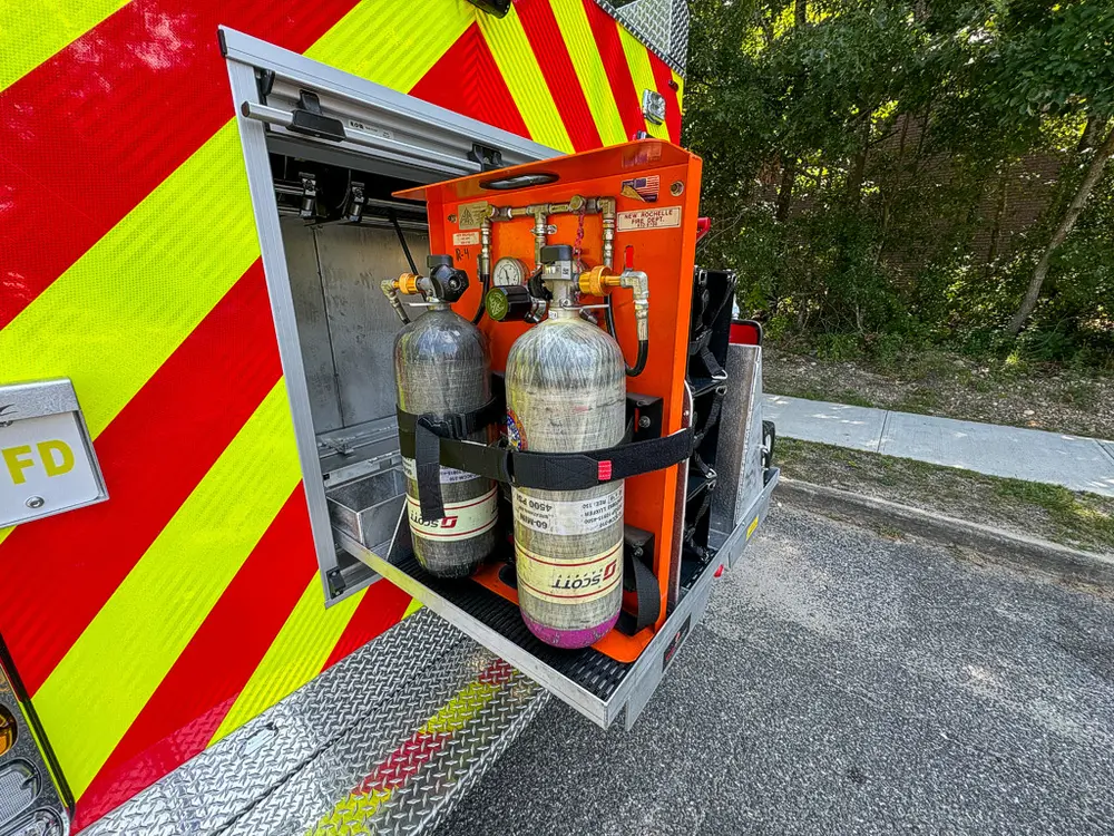 Rear compartment with multiple SCBA cylinders secured in rack.
