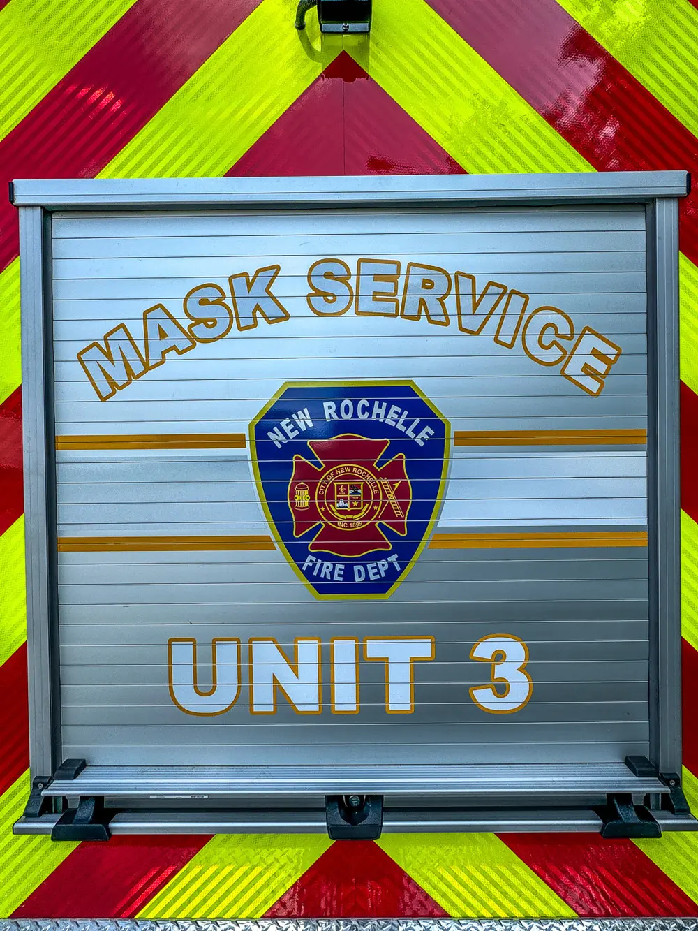 Close-up of rear roll-up door graphic reading Mask Service Unit 3.