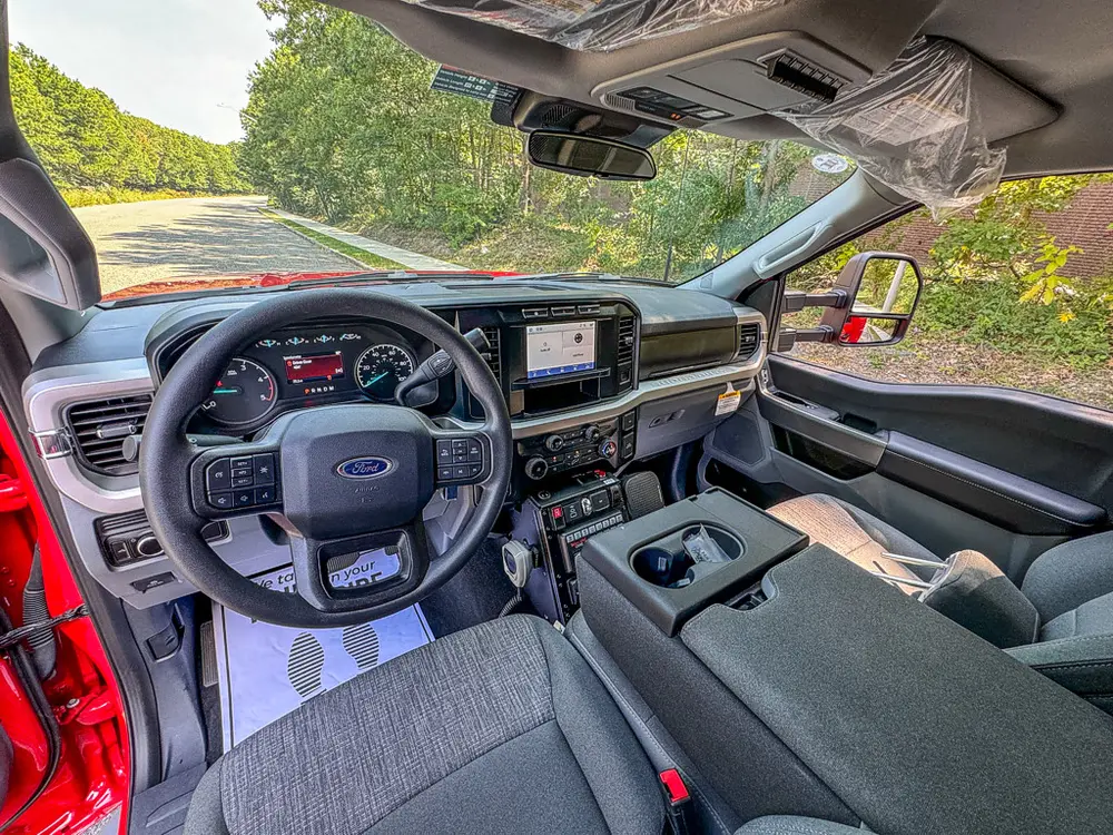 Front cabin interior view with steering wheel and center console.