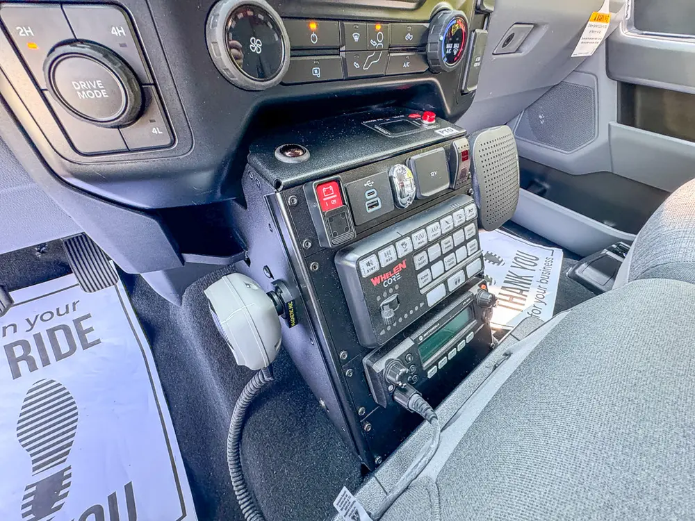 Console controls close-up from driver side with switches and keypad.