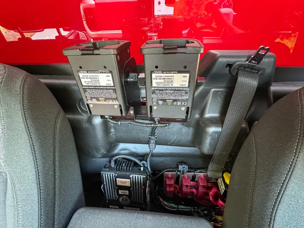Floor-mounted control levers and wiring at center tunnel.