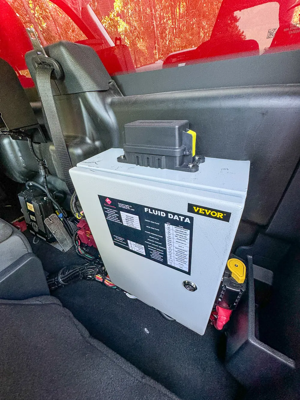 Rear cabin equipment module with fluid data label and wiring.