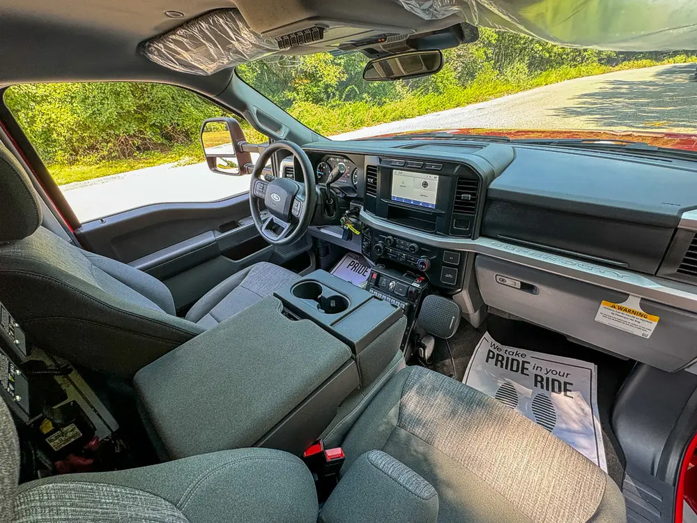 Wide front interior view with dashboard and center work console.