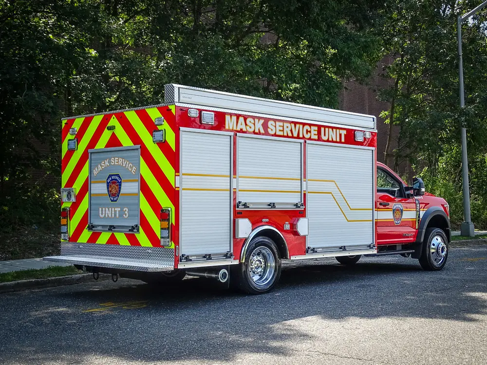 Rear-right three-quarter view of utility body and cab.