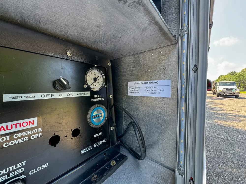 Compartment interior close-up with pressure gauge and caution labels.