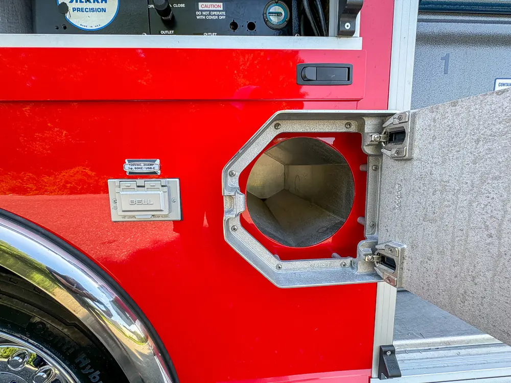 Octagonal side intake hatch open showing capped fitting.