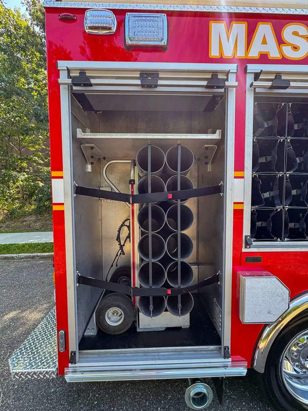 Rear-side vertical cylinder rack with black securing strap.
