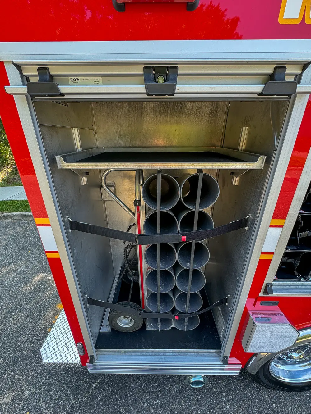 Open vertical cylinder compartment with stacked tube holders.