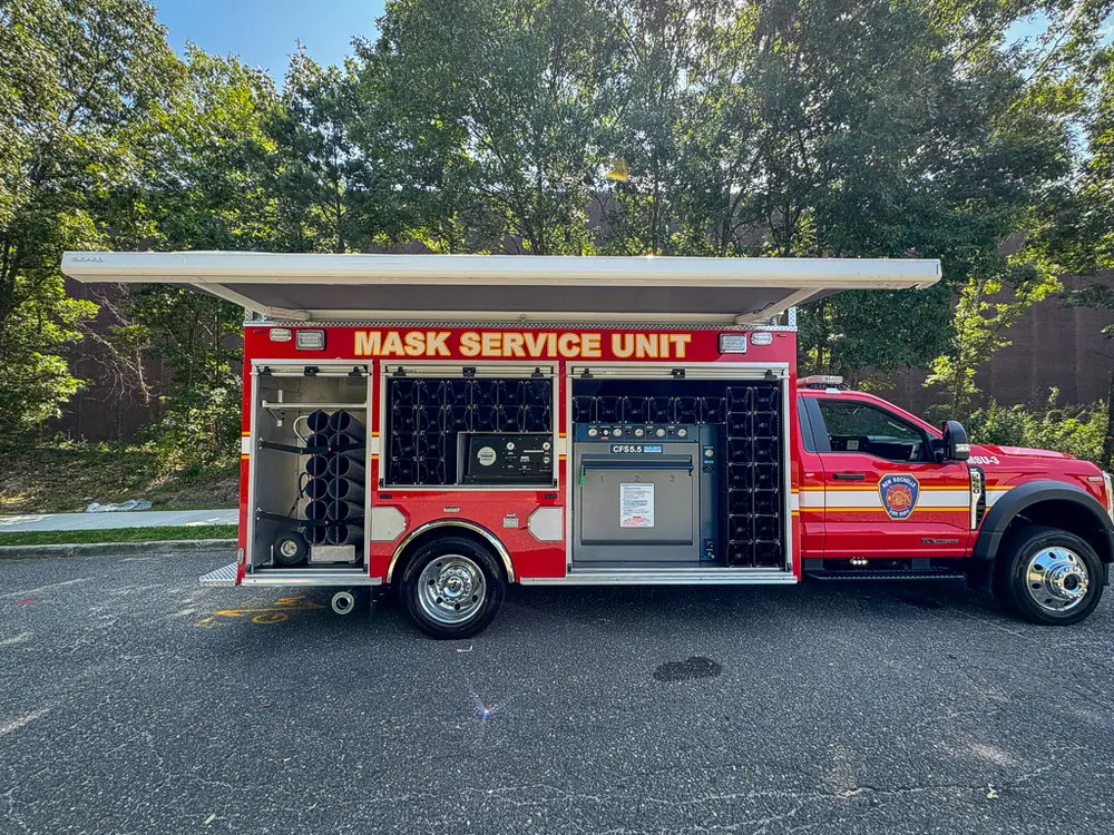 Left-side profile with long compartment open and upper awning raised.