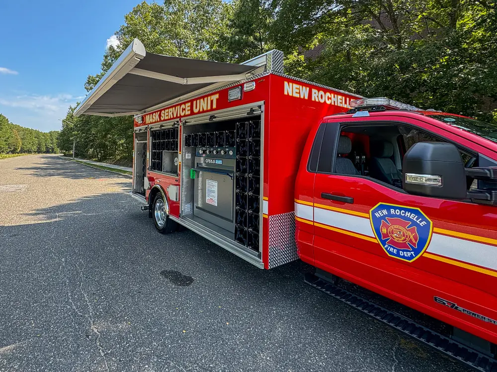 Right-side profile with upper compartment doors raised and bays open.