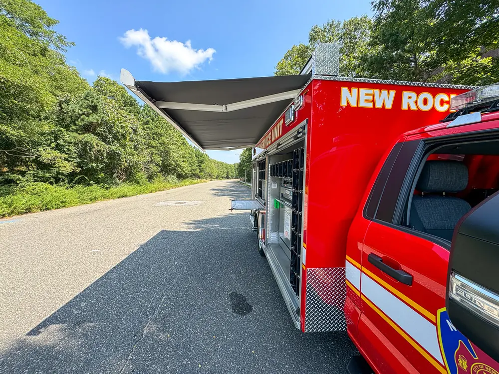 Rear-right angle with upper hatch raised over side equipment bay.