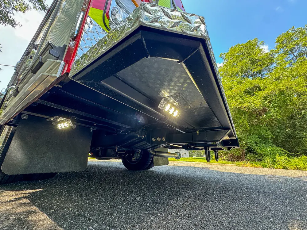 Low underside view with side awning/door panel raised overhead.