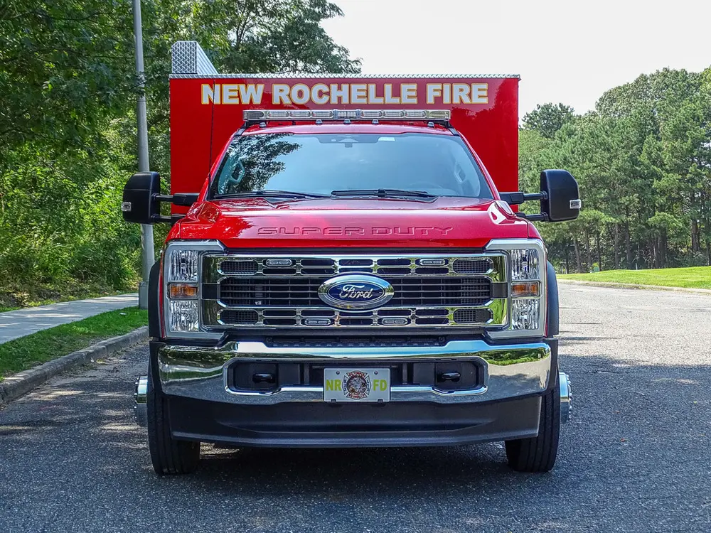 Head-on front view showing grille, bumper, and windshield lettering.