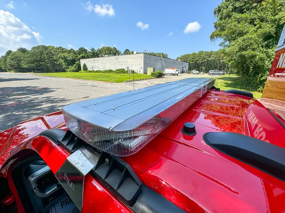 Cab roofline close-up with silver roof panel and mounted lights.
