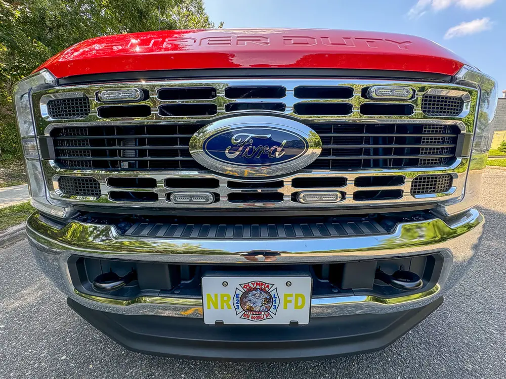 Head-on grille close-up with Ford emblem and front bumper.