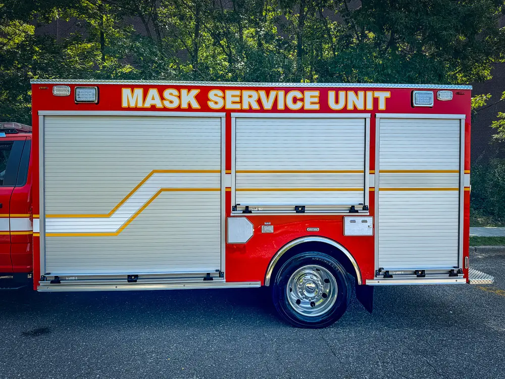 Right-side body view with roll-up doors and service unit lettering.
