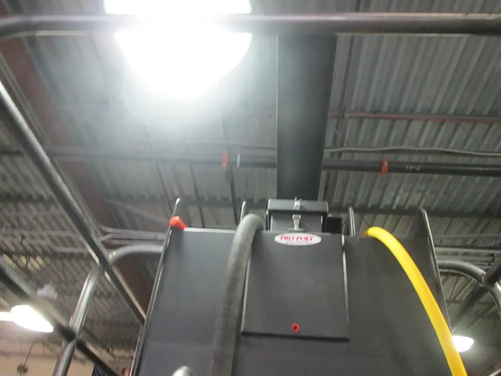 Exterior view of small fire truck showing cab, body compartments, and wheel/tire area.