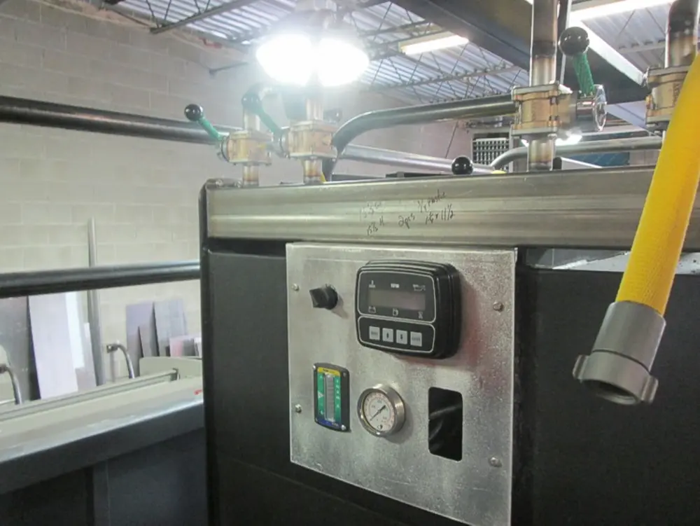 Exterior view of small fire truck showing cab, body compartments, and wheel/tire area.