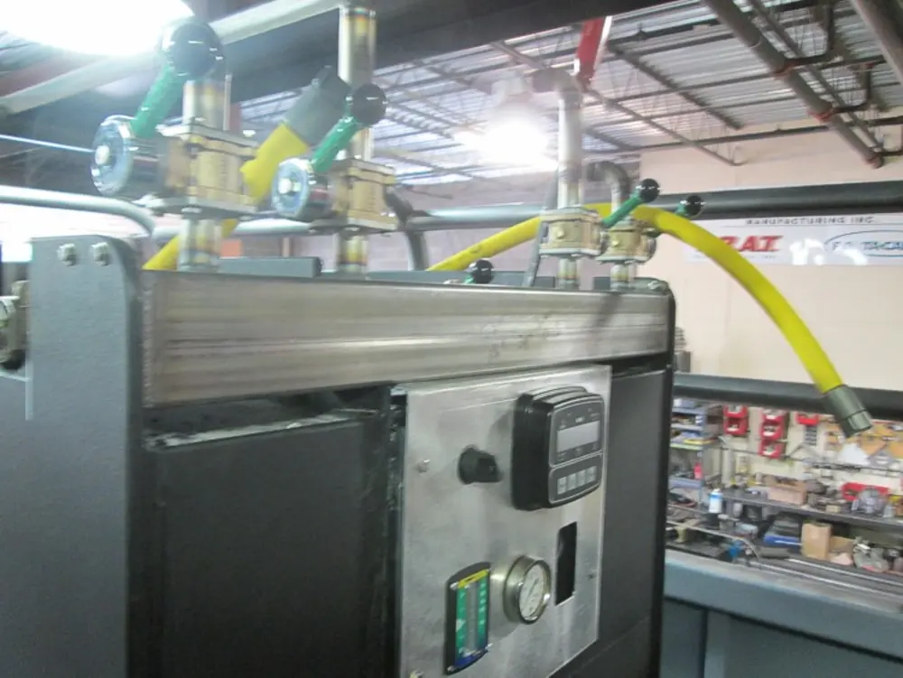 Exterior view of small fire truck showing cab, body compartments, and wheel/tire area.