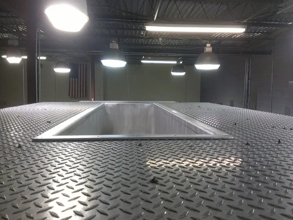 Exterior view of small fire truck showing cab, body compartments, and wheel/tire area.