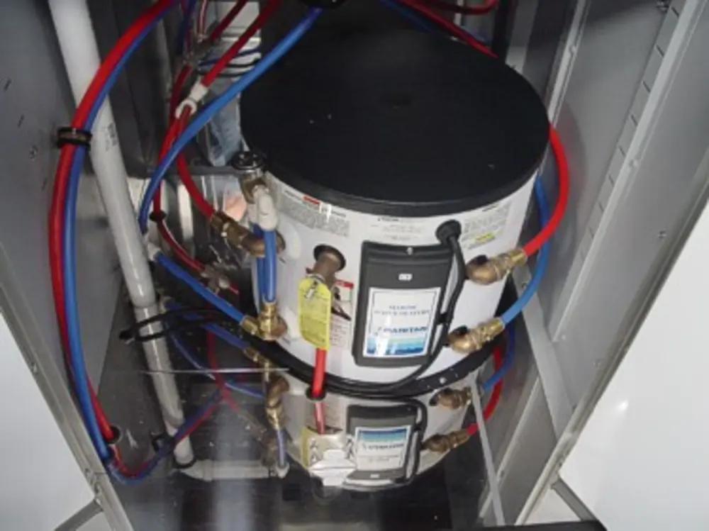 Exterior view of small fire truck showing cab, body compartments, and wheel/tire area.