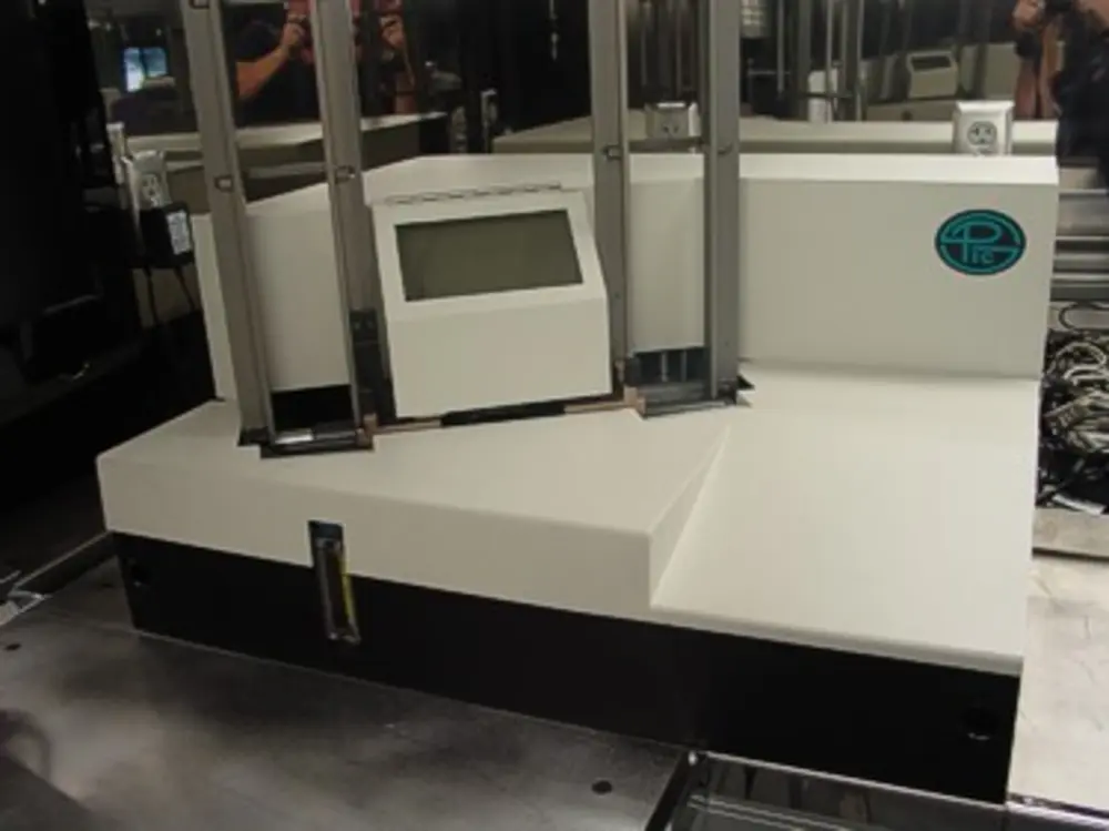 Exterior view of small fire truck showing cab, body compartments, and wheel/tire area.