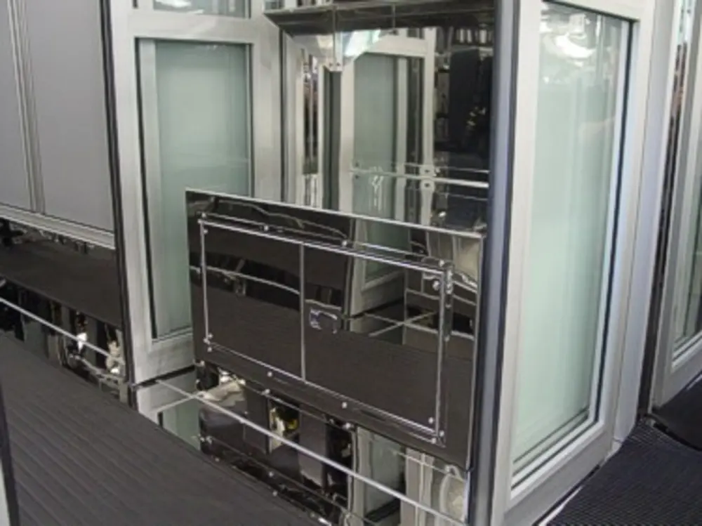 Exterior view of small fire truck showing cab, body compartments, and wheel/tire area.