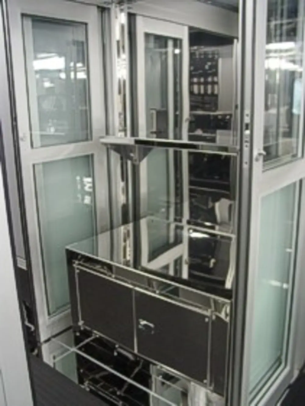 Exterior view of small fire truck showing cab, body compartments, and wheel/tire area.