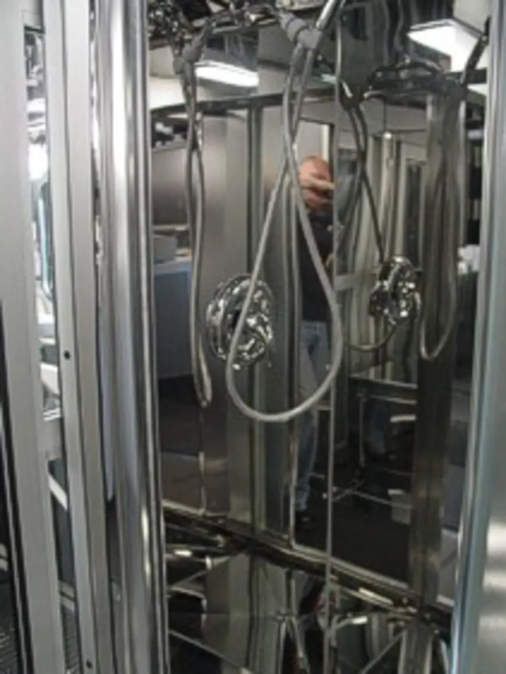 Exterior view of small fire truck showing cab, body compartments, and wheel/tire area.