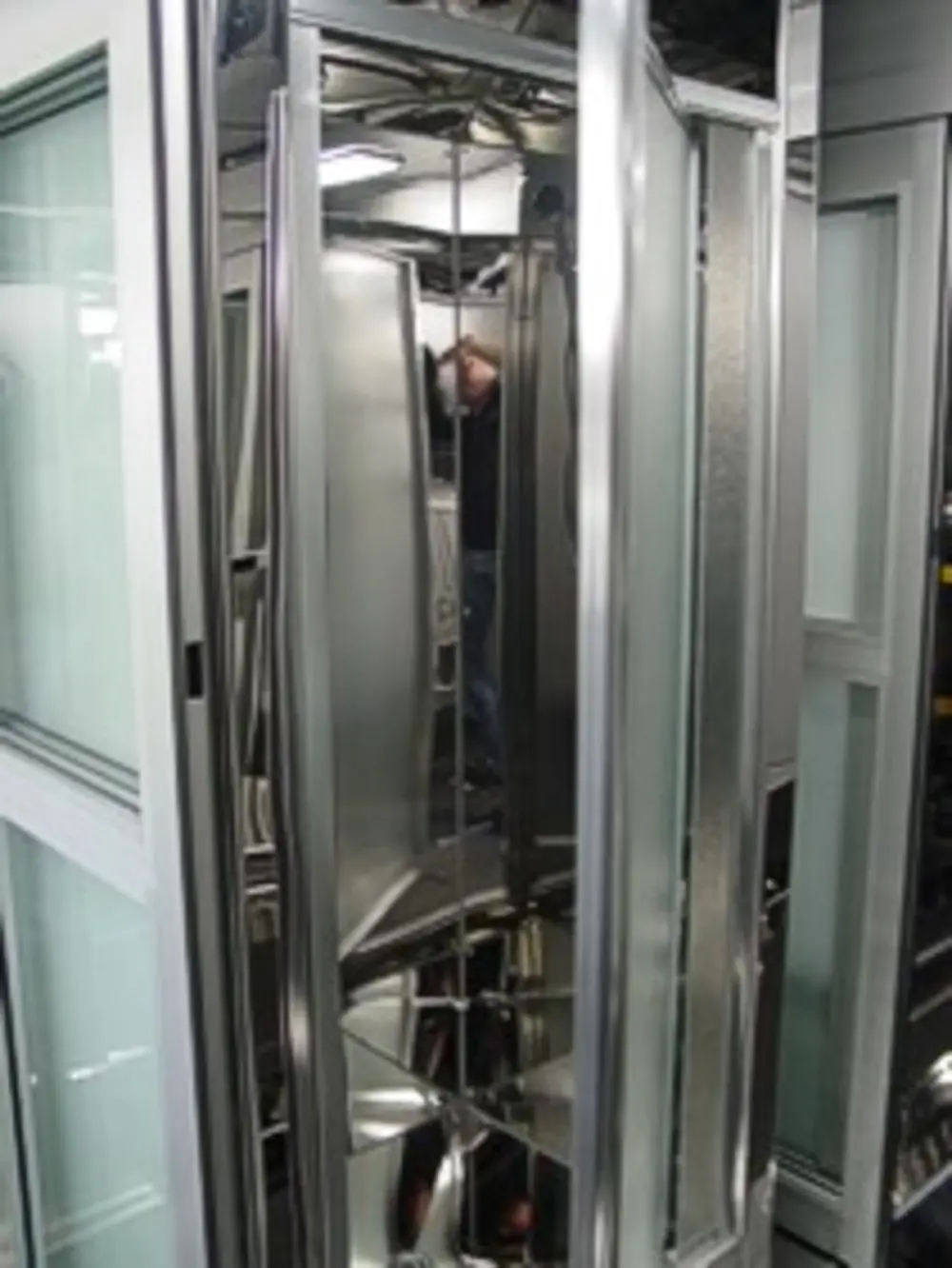 Exterior view of small fire truck showing cab, body compartments, and wheel/tire area.