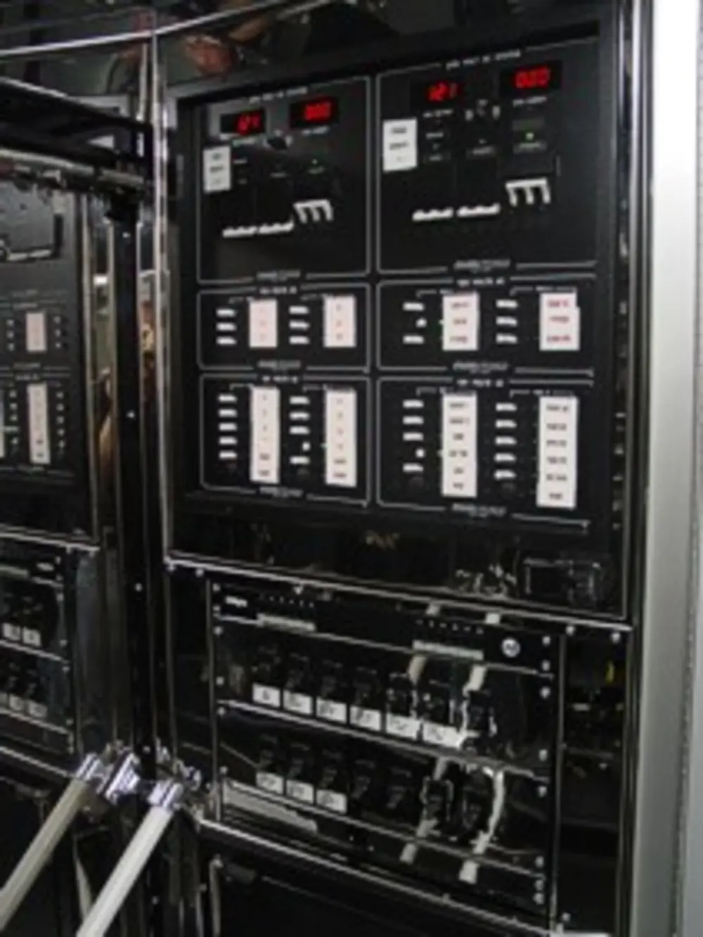 Exterior view of small fire truck showing cab, body compartments, and wheel/tire area.