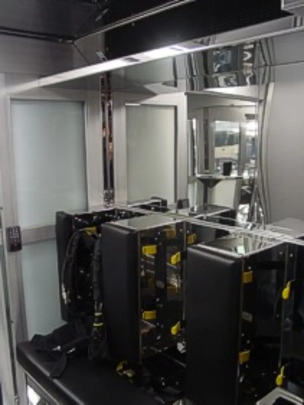 Exterior view of small fire truck showing cab, body compartments, and wheel/tire area.