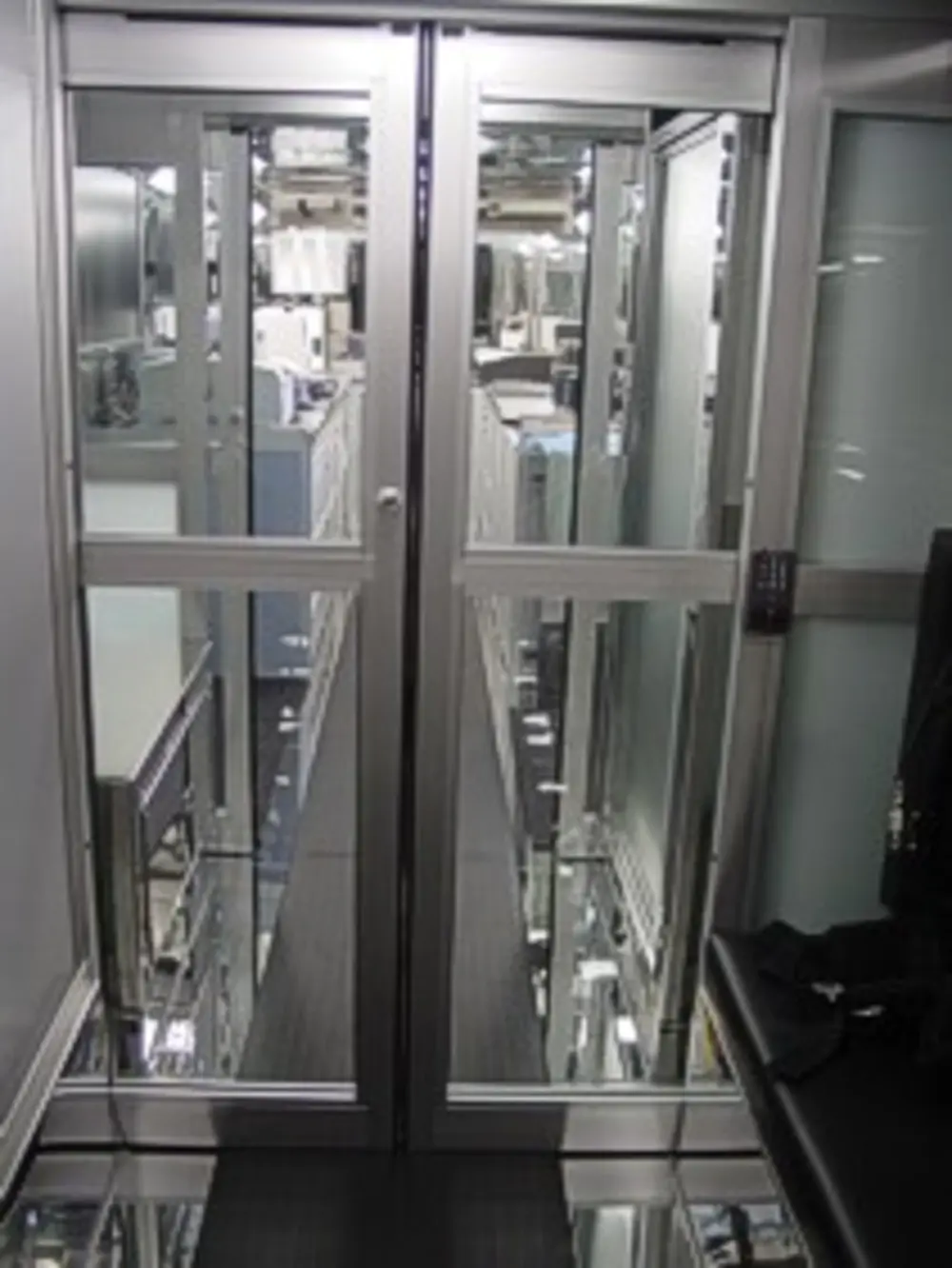 Exterior view of small fire truck showing cab, body compartments, and wheel/tire area.