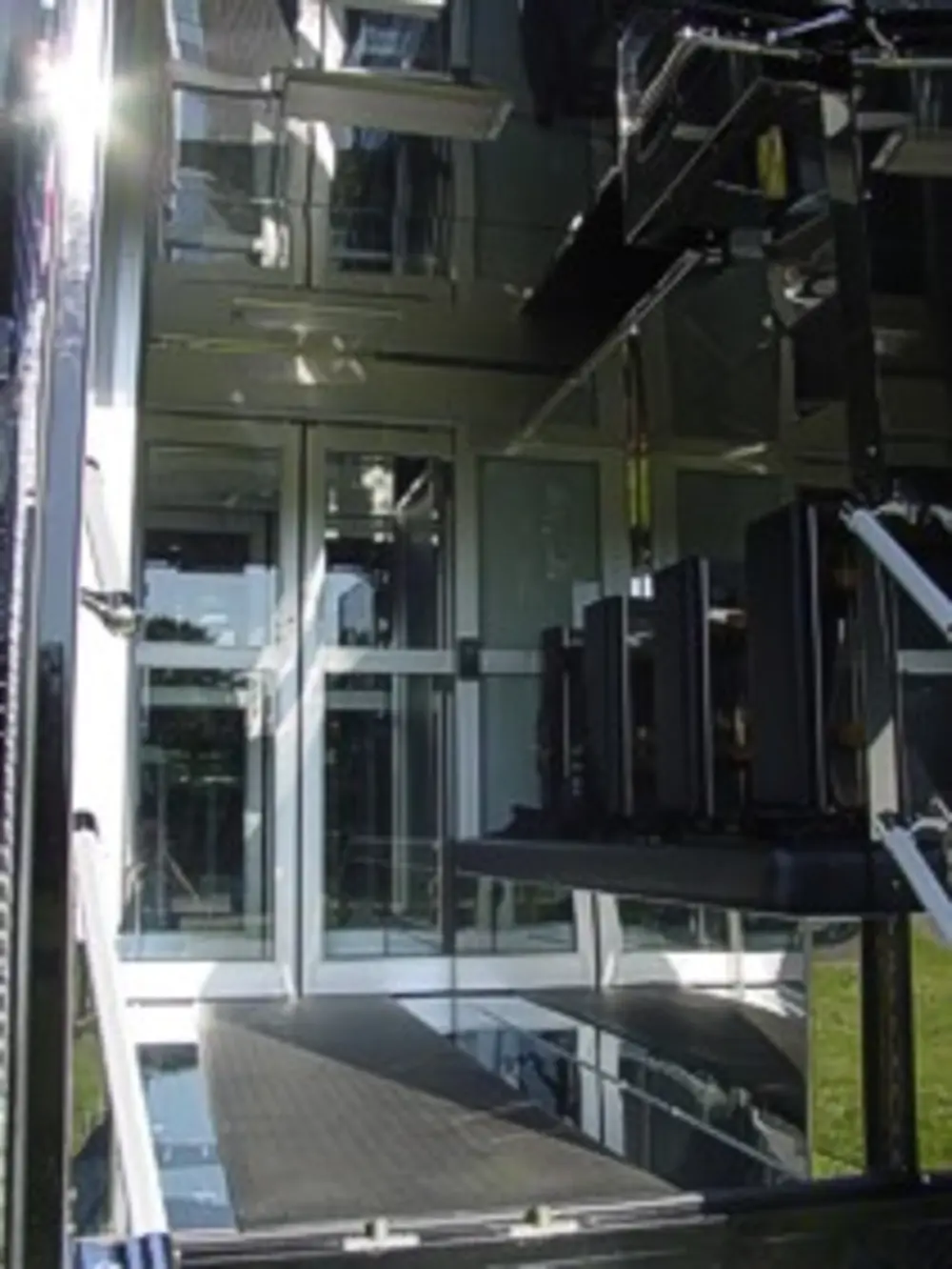 Exterior view of small fire truck showing cab, body compartments, and wheel/tire area.