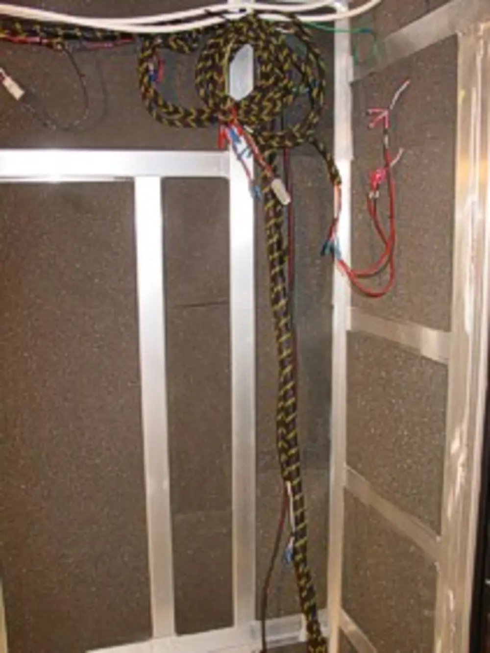 Exterior view of small fire truck showing cab, body compartments, and wheel/tire area.